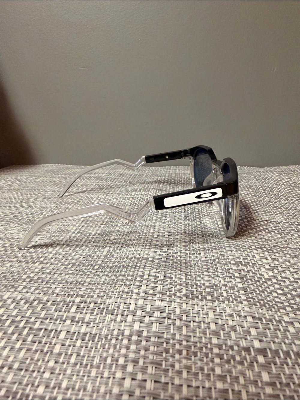 Oakley Clear Frame Sunglasses with Black Temples and Dark Lenses